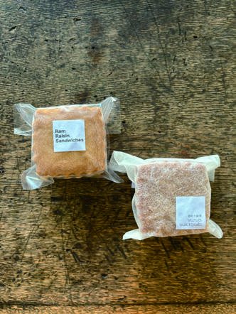 Two sandwich cookies: rum raisin, and sake lees with red bean